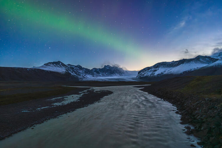 The Northern Lights are still visible as dawn breaks over Iceland. The Skaftatell glacier and Vatnajokull National Park form the perfect bacground for the Aurora Borealis.